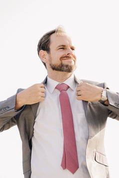 Dusty Rose Tie worn with a white shirt and gray suit jacket.