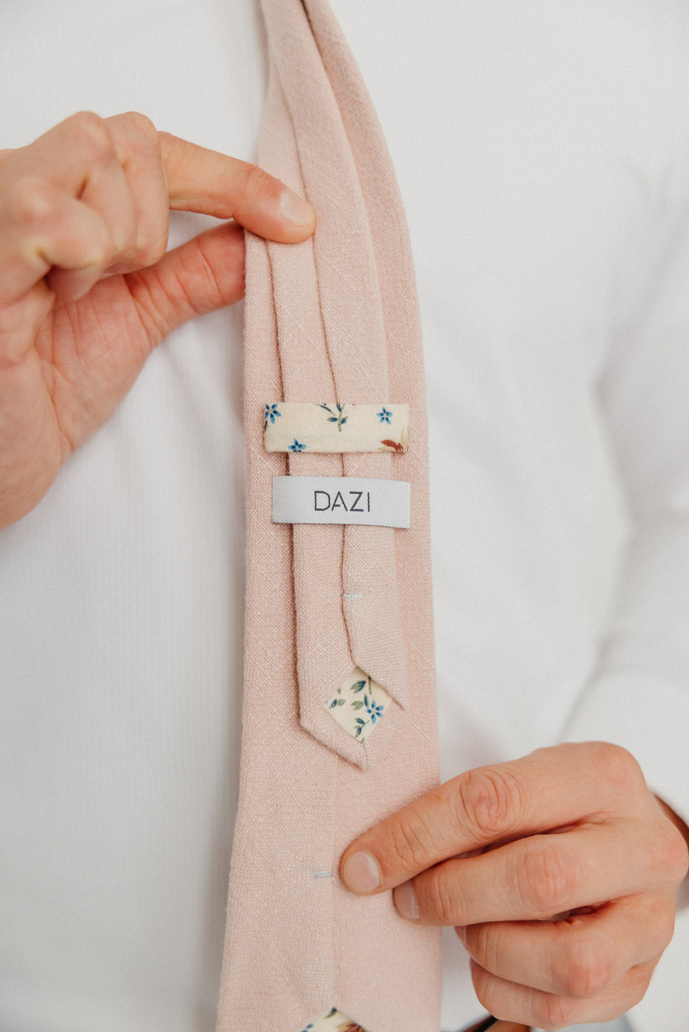 Mauve tie worn with a white shirt.