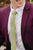 Moss tie worn with a white shirt and plum purple suit jacket.