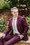 Moss tie worn with a white shirt and plum purple suit.