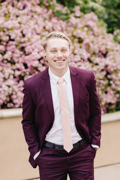 Pale Pink Tie worn with a white shirt and plum purple suit.