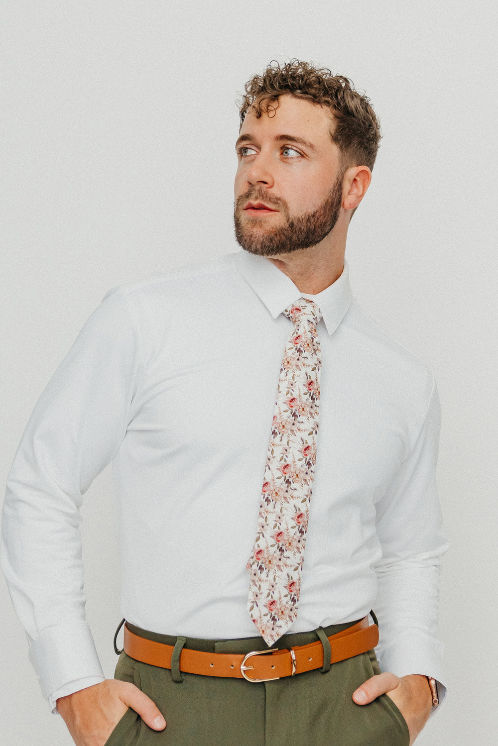 Quicksand Roses tie worn with a white shirt, brown belt and olive green pants.