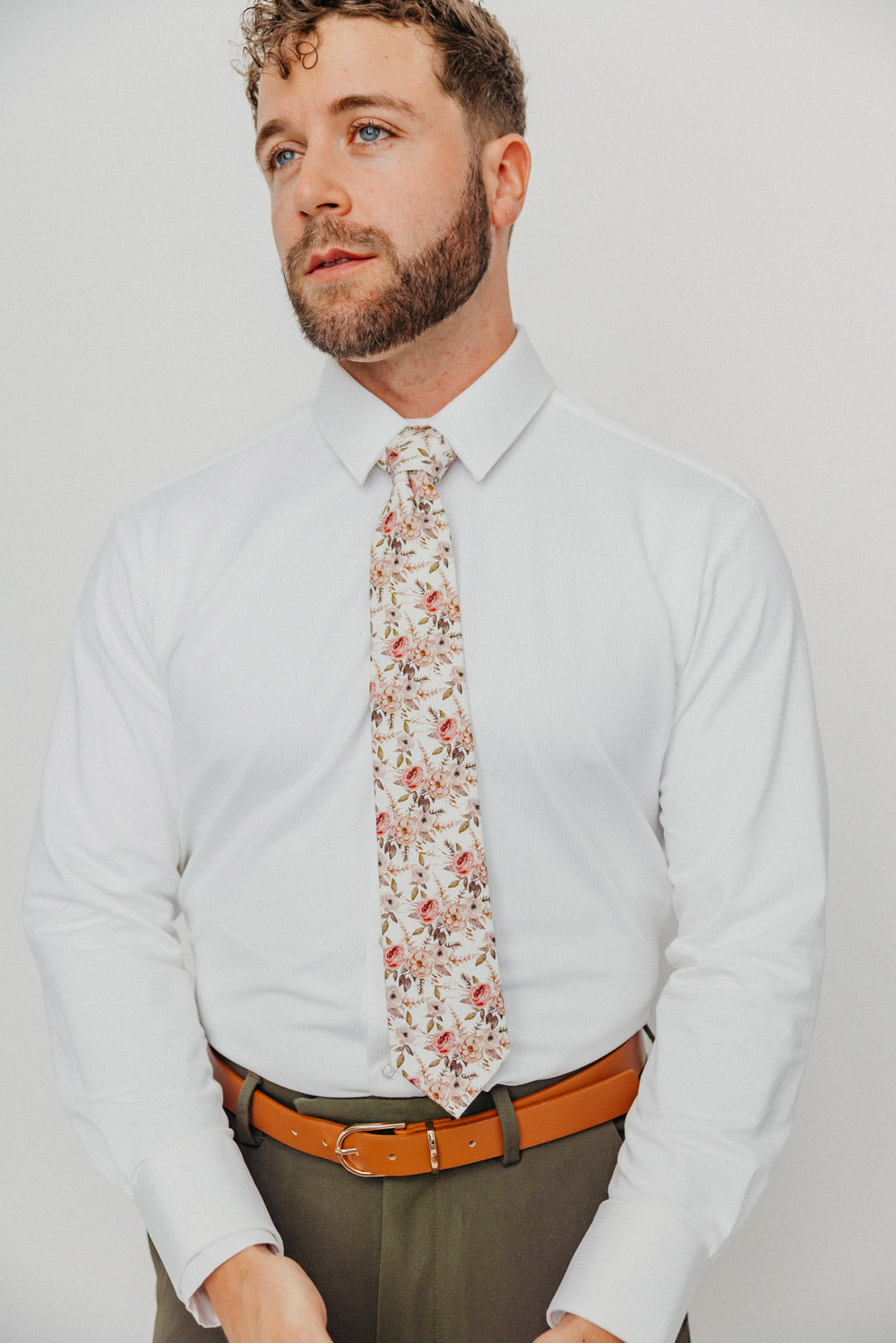 Quicksand Roses tie worn with a white shirt, brown belt and olive green pants.