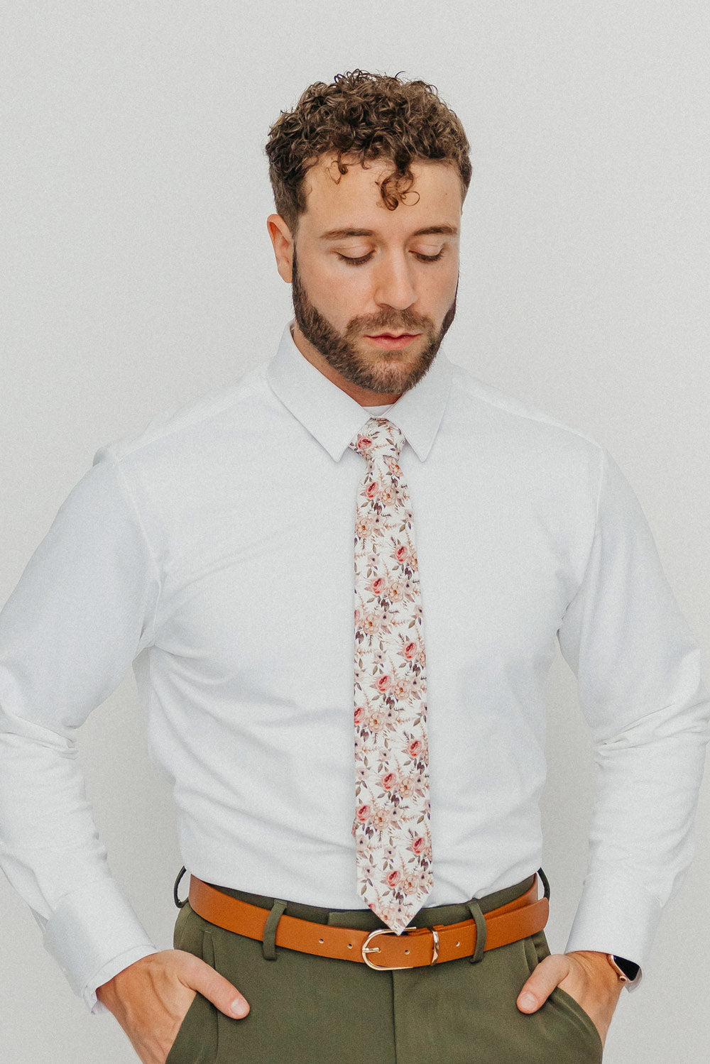 Quicksand Roses tie worn with a white shirt, brown belt and olive green pants.