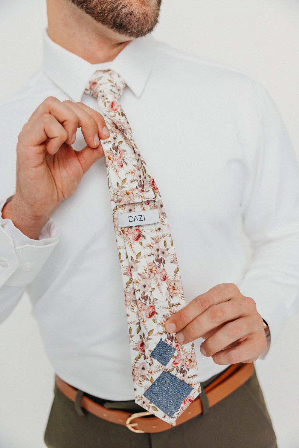 Quicksand Roses tie worn with a white shirt, brown belt and olive green pants.