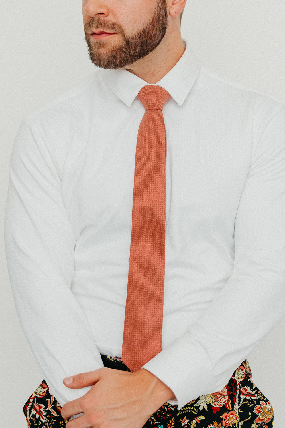 Sedona tie worn with a white shirt, black belt and floral pants.