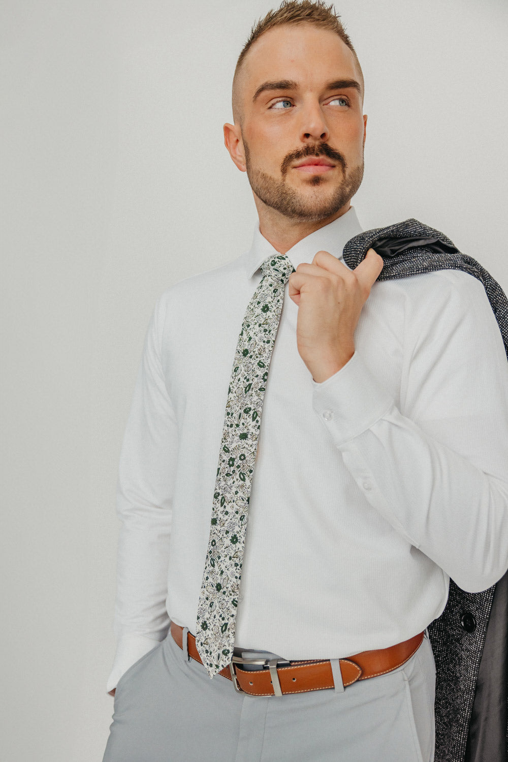 Silhouette tie worn with a white shirt, brown belt and gray pants.