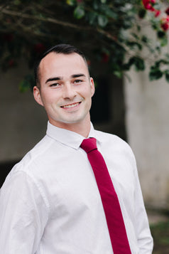 Wine necktie worn with a white shirt.