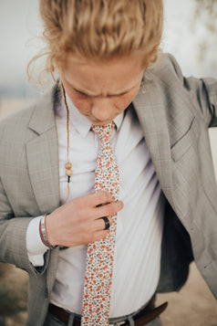 Peach Blossom tie worn with a white shirt and gray window pane suit.