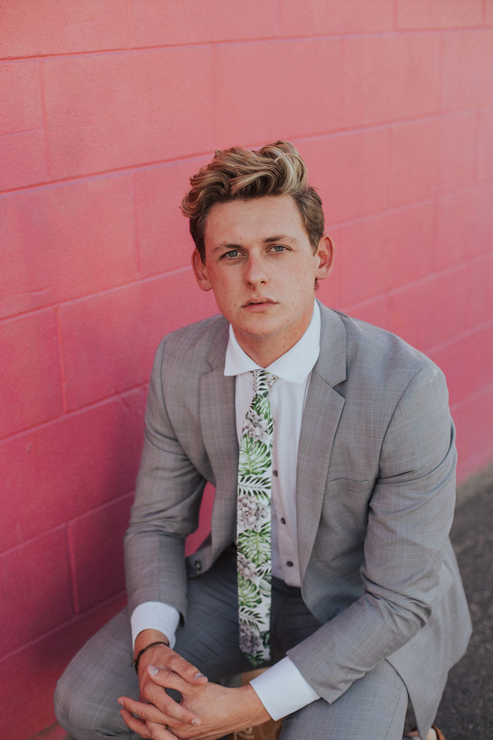 Aloe tie worn with a white shirt and light gray textured suit.