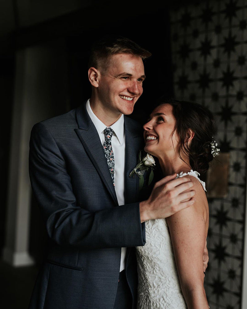 Atlanta tie worn by groom at a wedding with a white shirt and dark gray suit. 