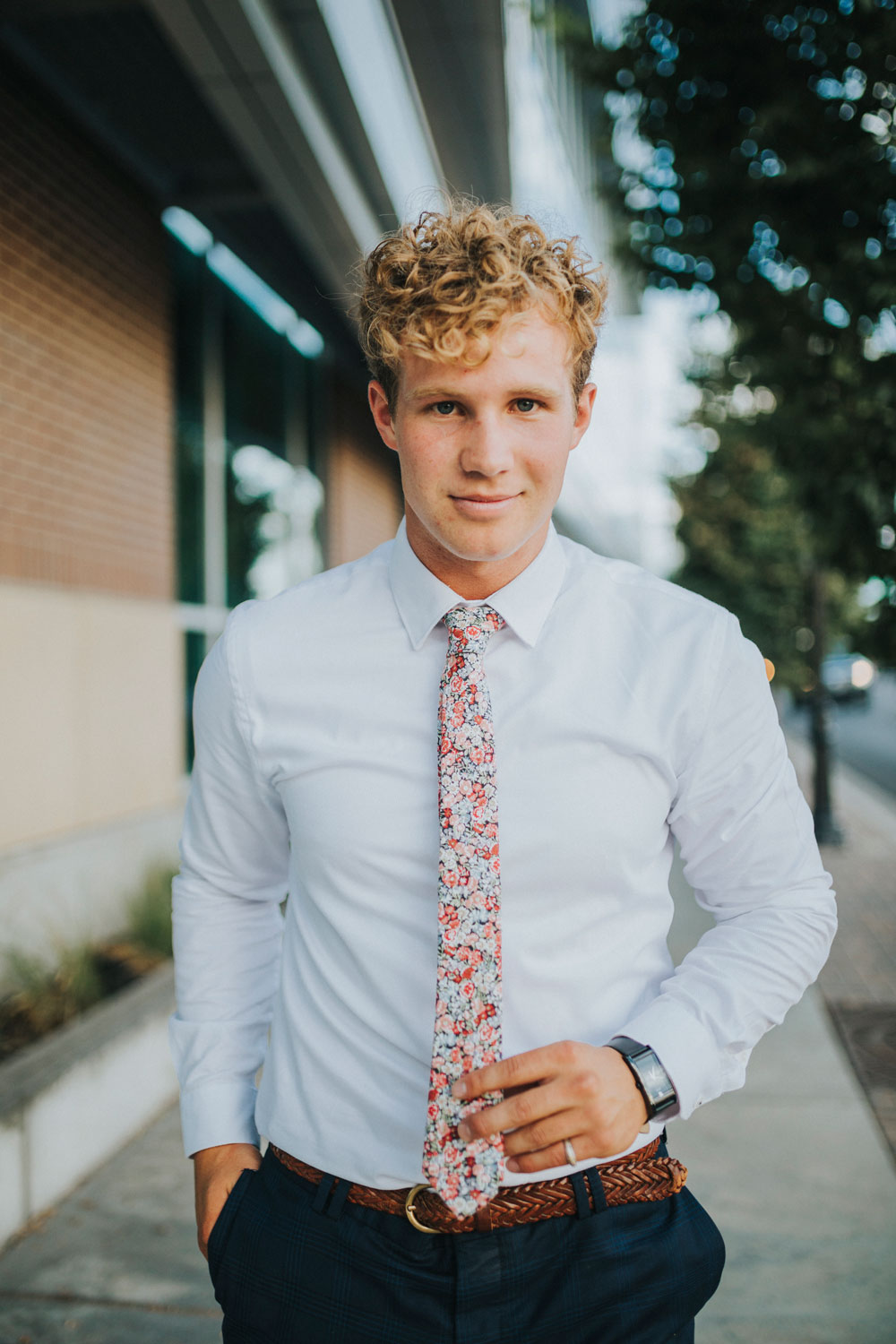 Bed of Roses tie worn with a white shirt, brown belt and blue pants.