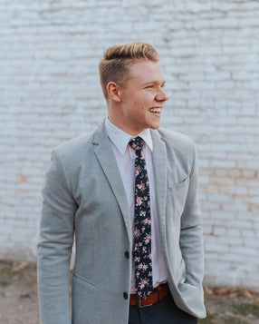 Bittersweet tie worn with a whit shirt and gray suit jacket.