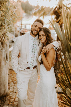 Blue bloom tie worn with a white shirt and light tan suit.