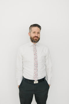 Burning Brush tie worn with a white shirt and charcoal gray pants.