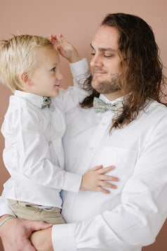 Calla Lily pre-tied bow tie worn by a father and son with a white shirt and tan pants.