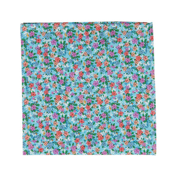 Dahlia Pocket Square. Light blue background with a variety of small pink, red, salmon and white flowers and green leaves. 