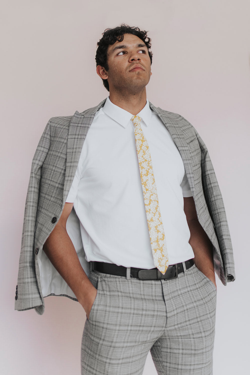 Daisy Tie worn with a white shirt and gray plaid suit. 