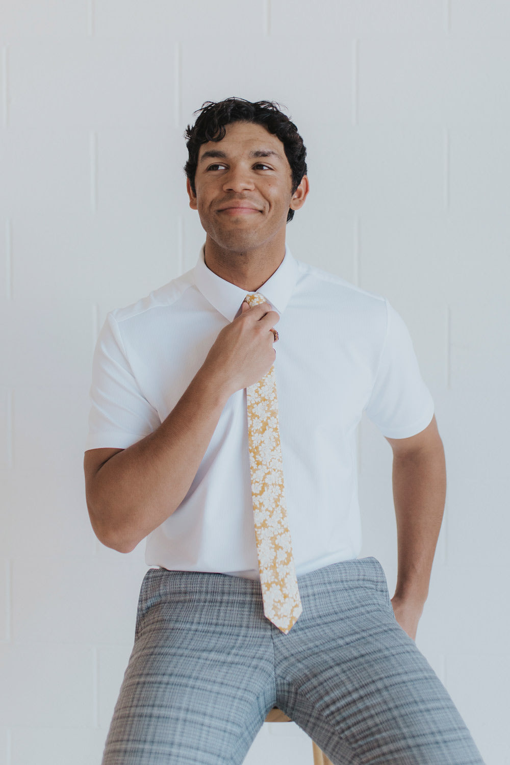 Daisy Tie worn with a white shirt and gray plaid suit pants.