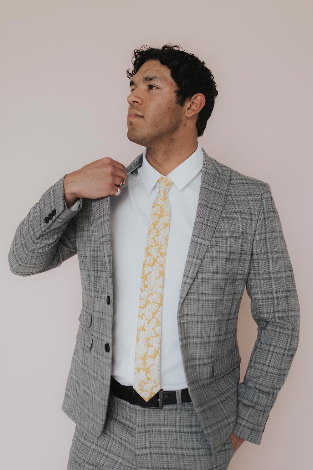 Daisy Tie worn with a white shirt and gray plaid suit.