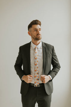 Desert Poppy tie worn with a white shirt, black suit jacket, black belt and black pants.