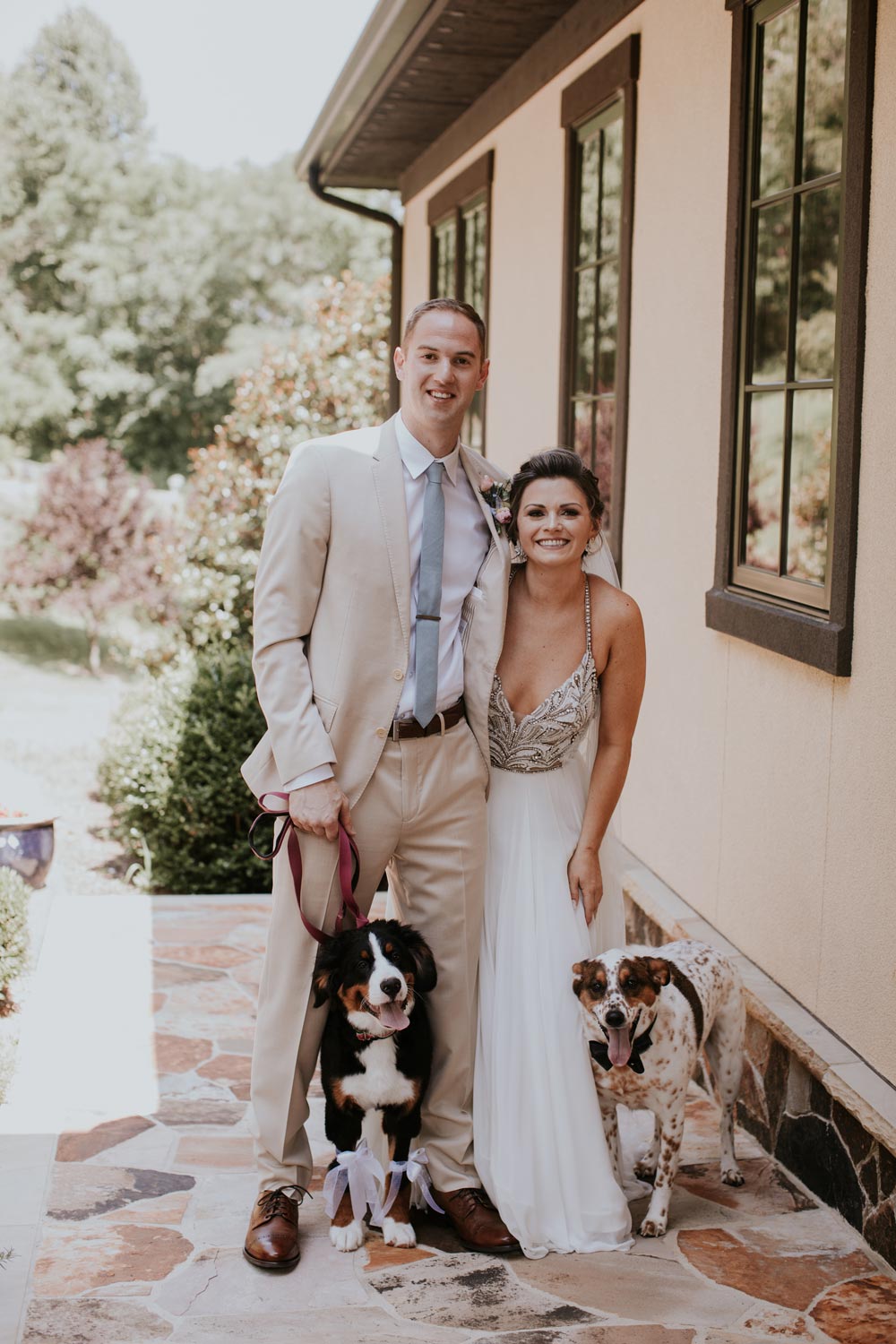 Dusty tie worn by groom at a wedding with white shirt and cream suit.