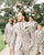 Dusty tie worn by groom at a wedding with white shirt and cream suit.