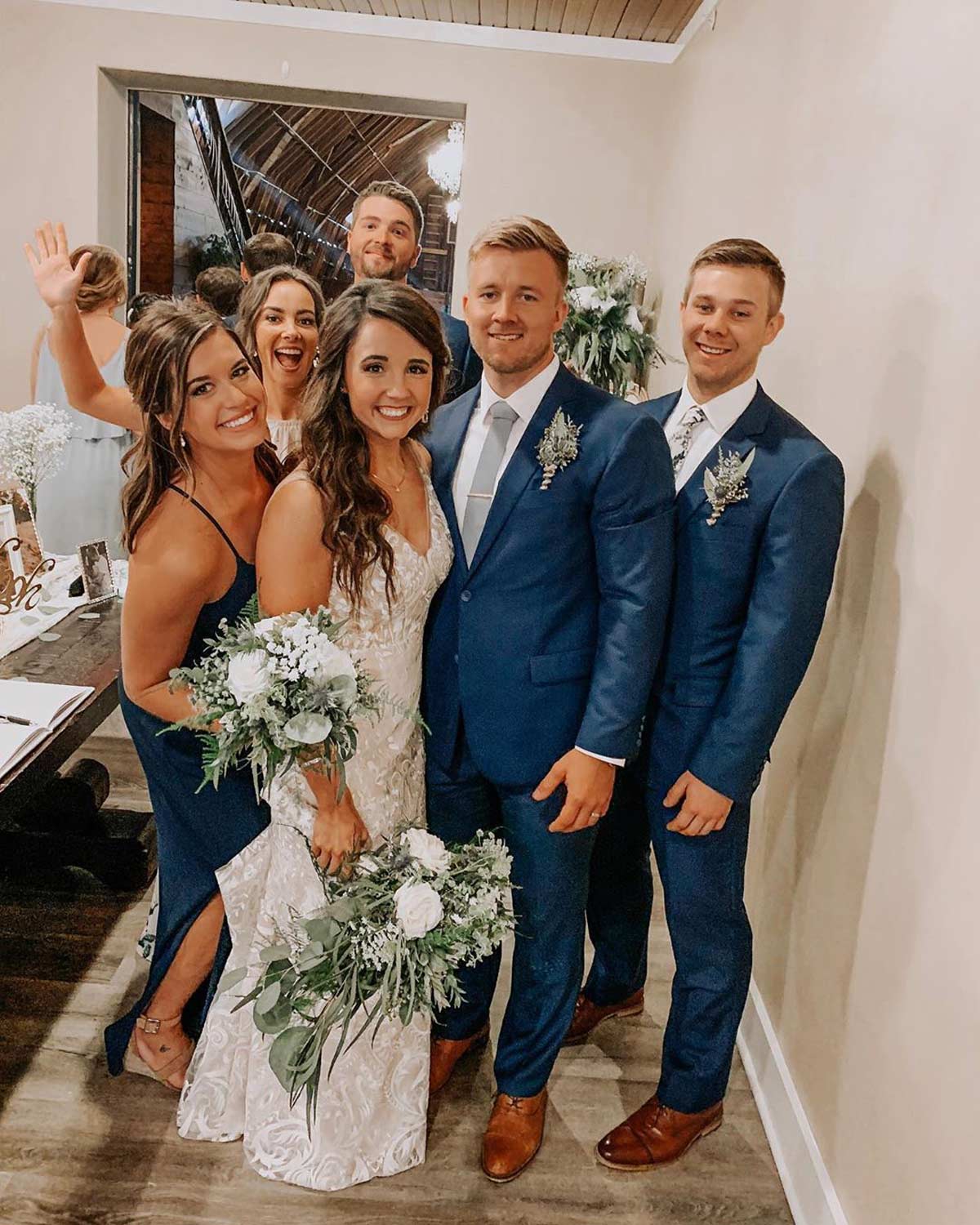 Dusty tie worn by groom at a wedding with white shirt, navy suit, and brown shoes.