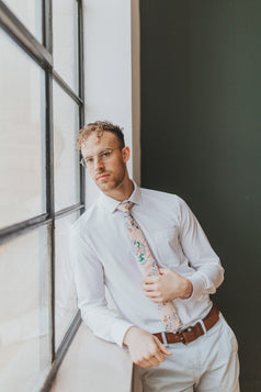 Dusty Lily tie worn with a white shirt, brown belt and gray pants.