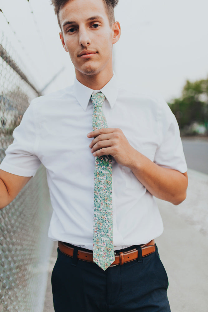 Faded Jade tie worn with a white shirt and navy blue pants.