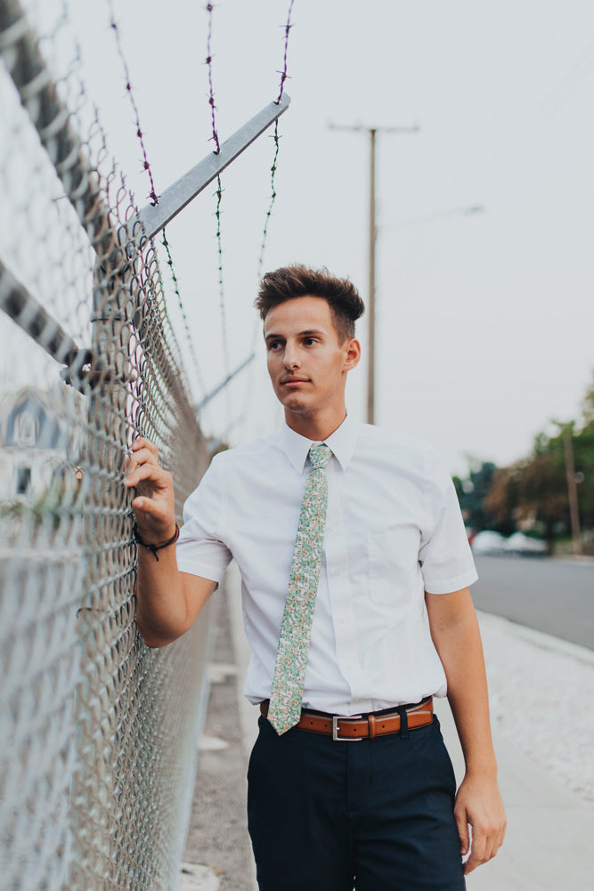 Faded Jade tie worn with a white shirt and navy blue pants.