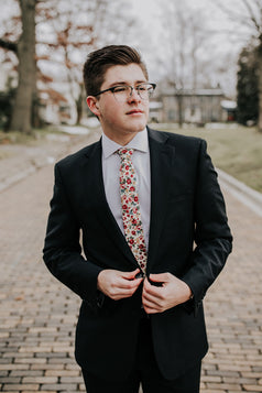 Fiore tie worn with a white shirt and black suit. 