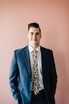 Fiore tie worn with a white shirt and blue suit. 