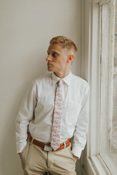 Hermosa tie worn with a white shirt, brown belt and khaki pants.