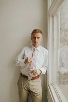 Hermosa tie worn with a white shirt, brown belt and khaki pants.