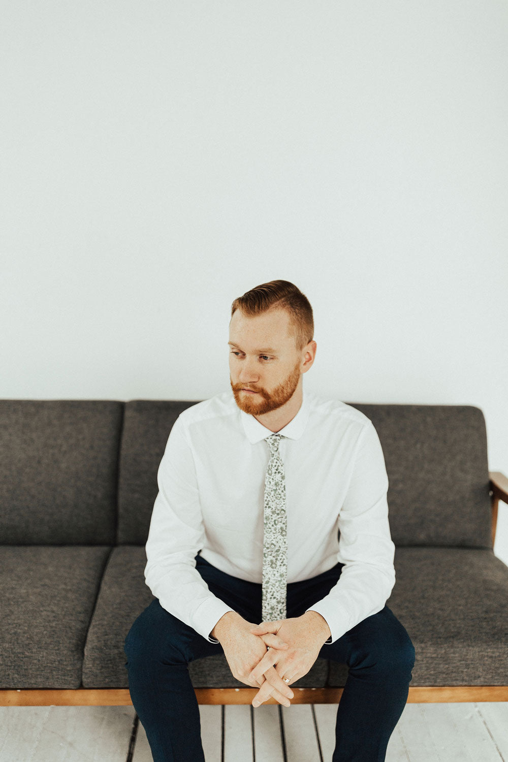 Hidden Garden tie worn with a white shirt and blue pants.