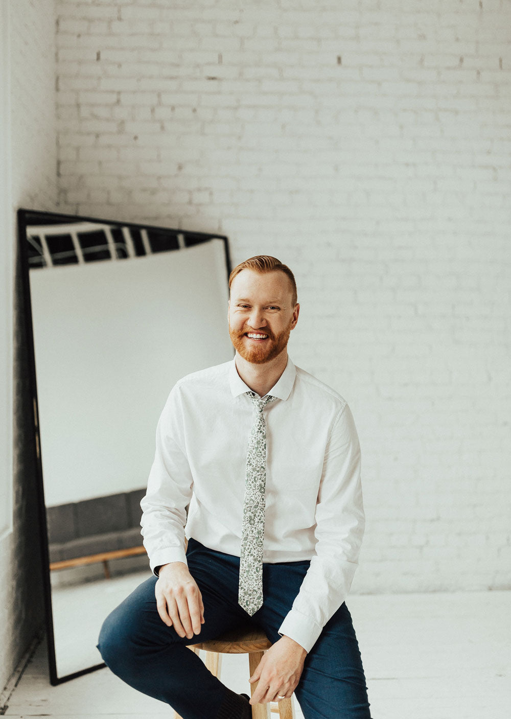 Hidden Garden tie worn with a white shirt and blue pants.