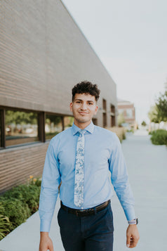 Indie Skye tie worn with a light blue shirt, black belt and navy blue pants.