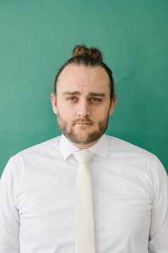 Ivory tie worn with a white shirt.