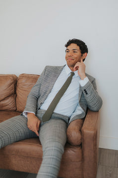 Jungle Tie worn with a white shirt and gray plaid suit.