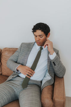 Jungle Tie worn with a white shirt and gray plaid suit.