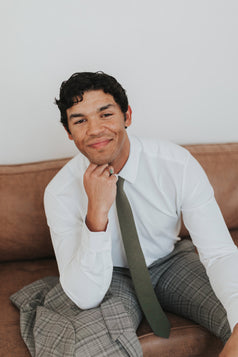 Jungle Tie worn with a white shirt and gray plaid suit.