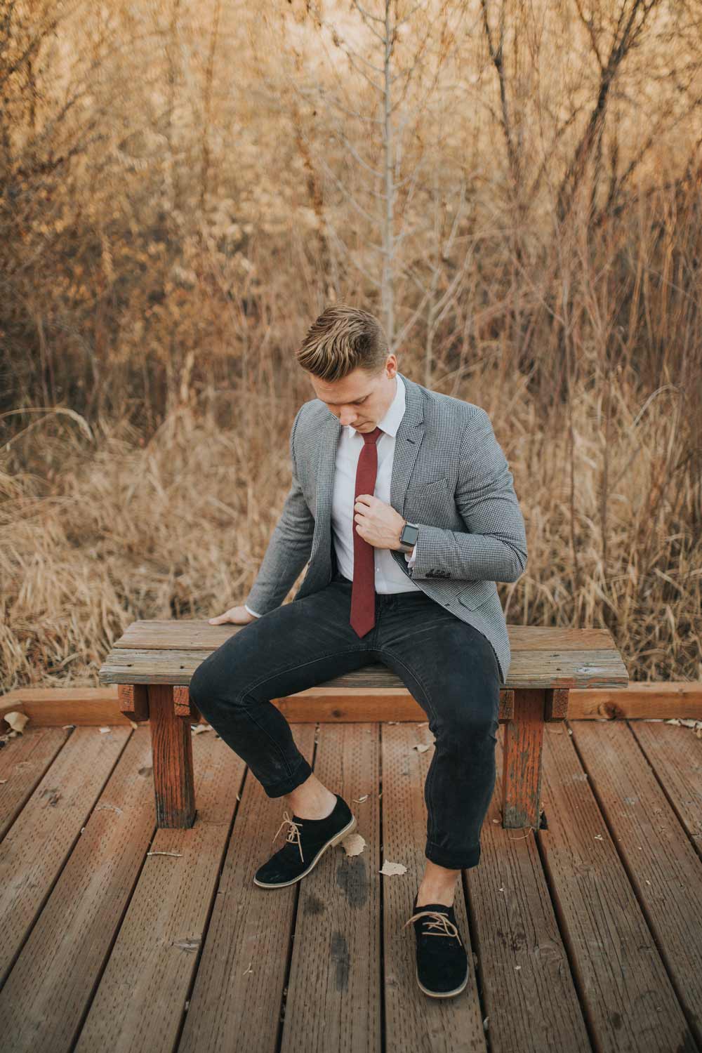 Merlot tie worn with a white shirt, gray textured suit jacket and navy pants.