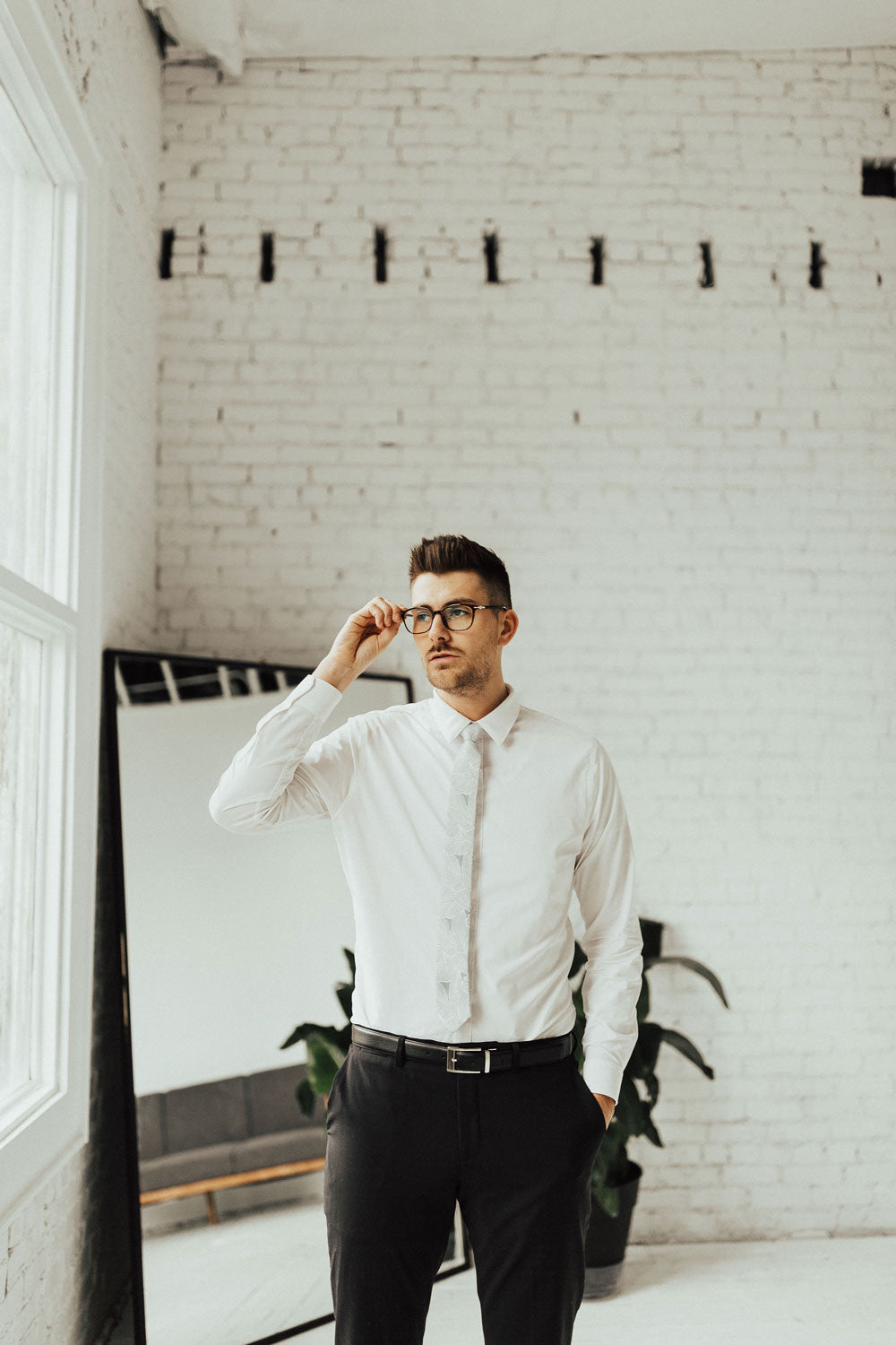 Palm tie worn with white shirt, black belt and black pants.