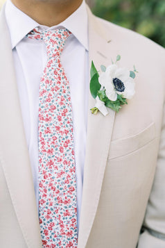 Peach Blossom tie worn with a white shirt and tan suit jacket.