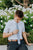 Powder tie worn with a white shirt, brown belt and navy blue pants.