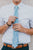 Powder tie worn with a white shirt, brown belt and navy blue pants.