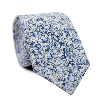 Powder Skinny Tie. White background with small navy and dusty blue flowers and black stems.