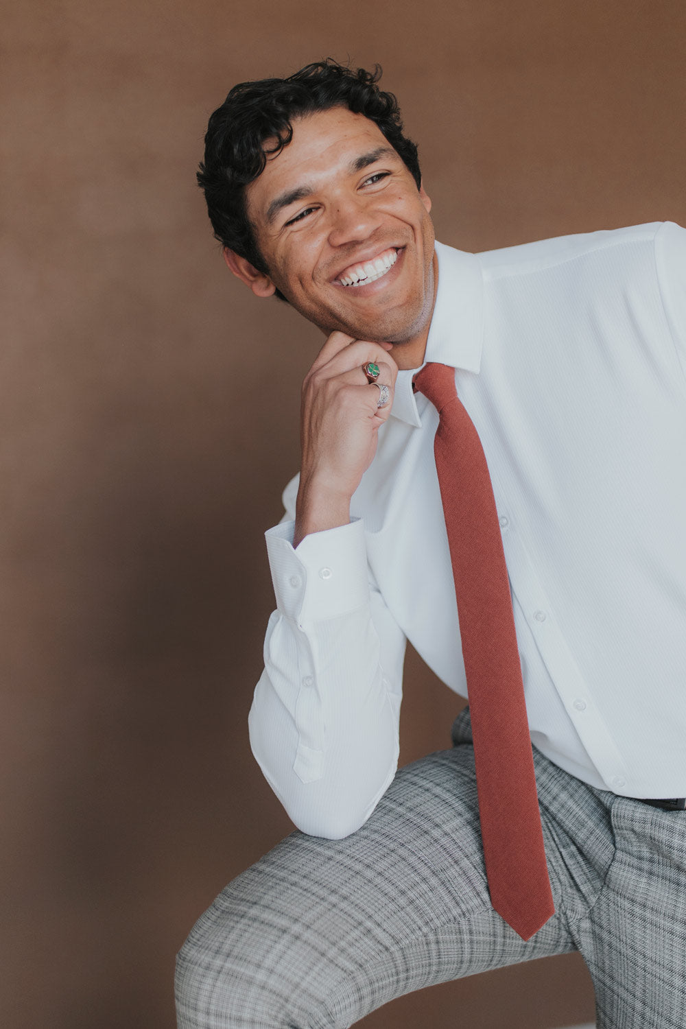 Rust Tie worn with a white shirt, black belt and gray plaid suit pants.