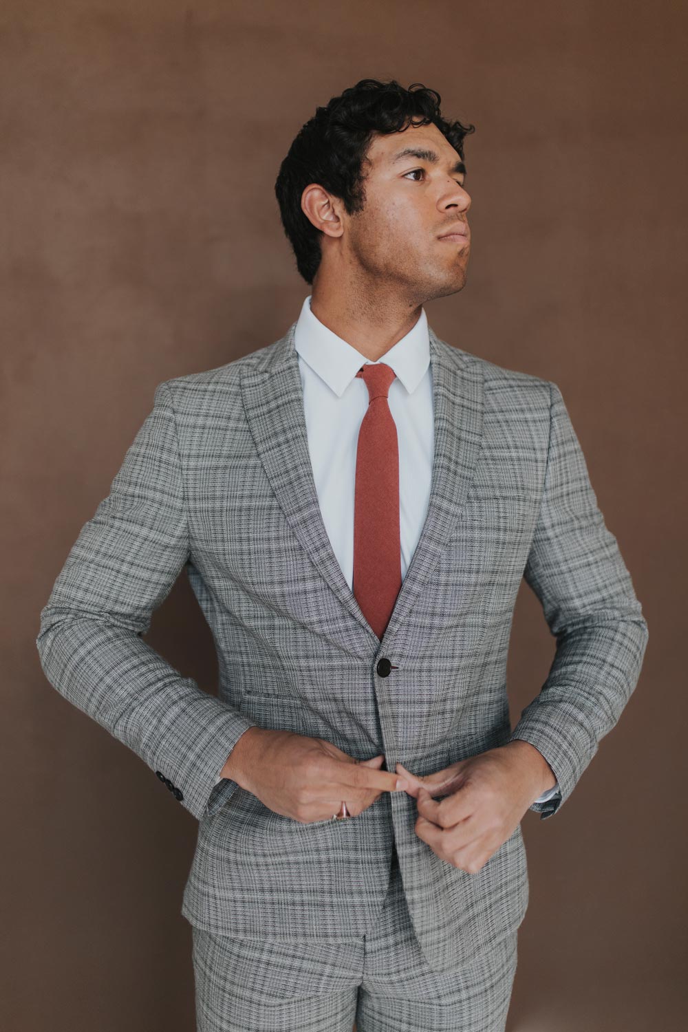 Rust Tie worn with a white shirt, black belt and gray plaid suit.